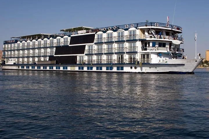 5-star ship sailing past palms on a 4-day Nile river cruise from Aswan to Luxor with Abu Simbel