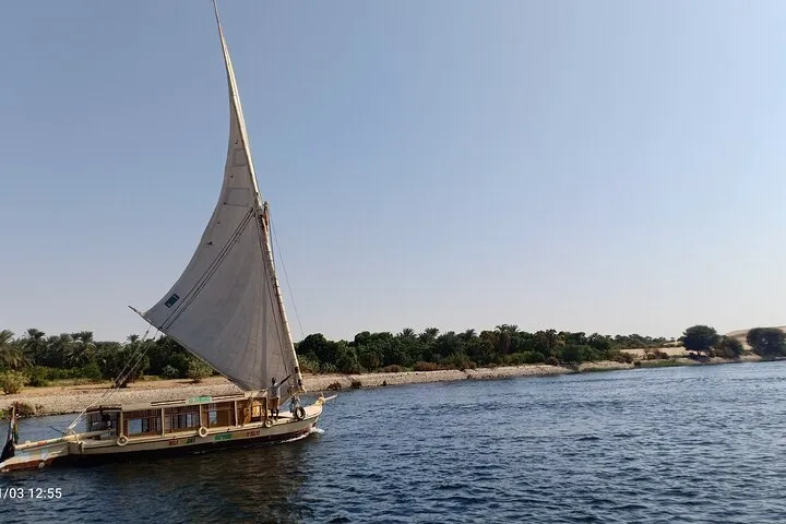 Felucca sailboat under a starry sky on an overnight Nile cruise from Aswan toward Luxor