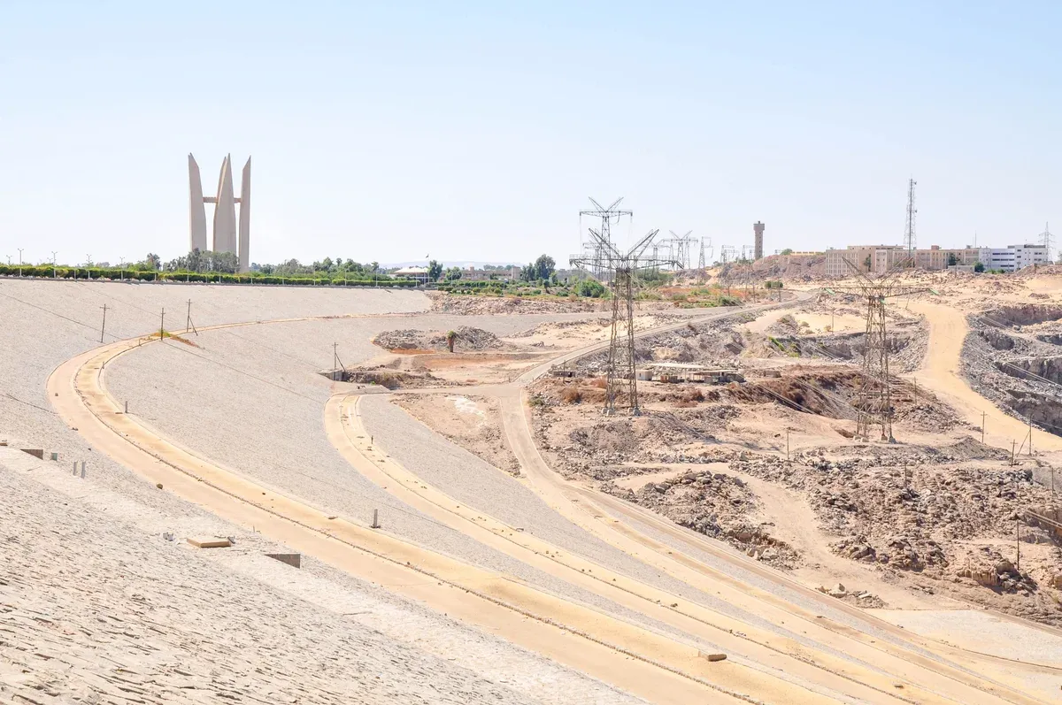 The embankment of the Aswan High Dam with the Lotus monument beyond, a stop on a Nile river cruise from Aswan