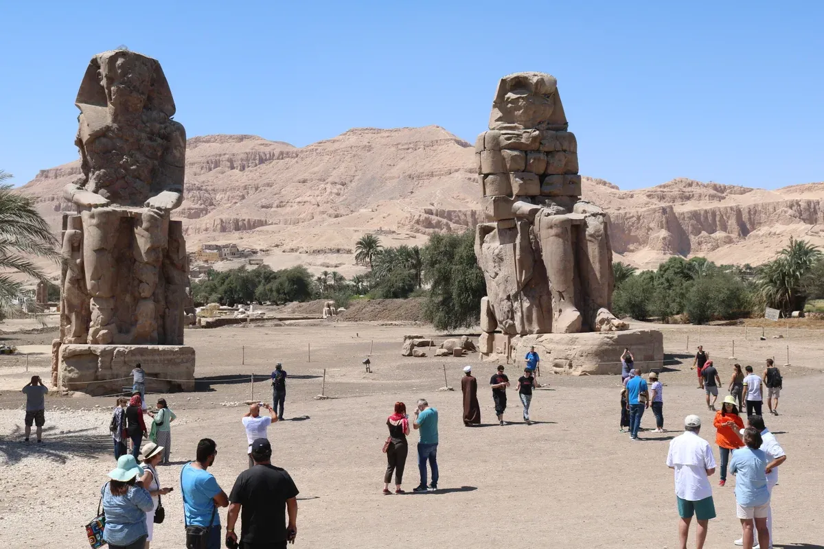 The two Colossi of Memnon standing on the Luxor West Bank, a common first stop of a Nile cruise day tour