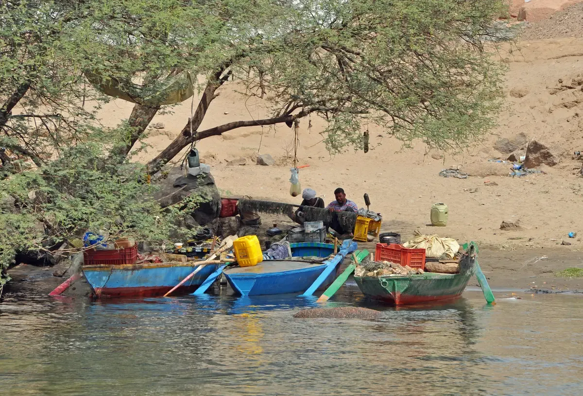 Small painted boats pulled up on the shore of Elephantine Island at Aswan on the Nile