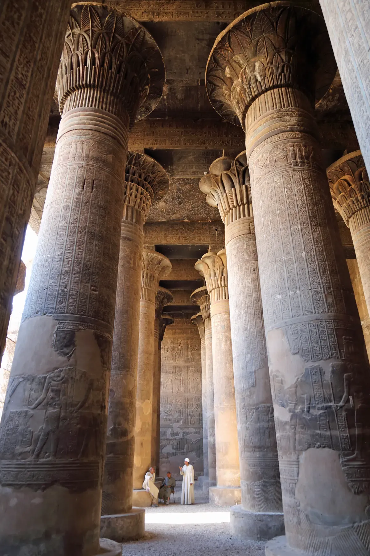 Tall carved columns of the hypostyle hall in the Temple of Khnum at Esna, a stop on a Nile river cruise