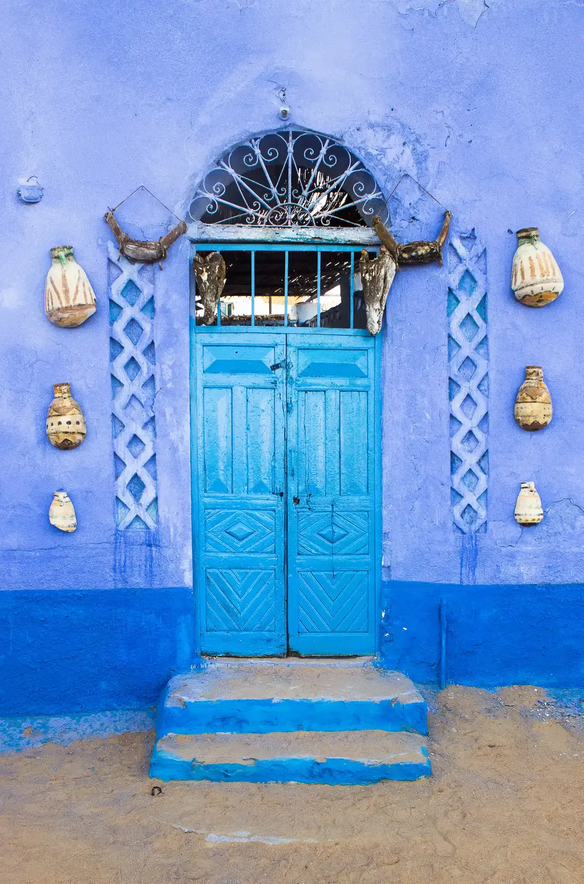 A blue painted door of a Nubian house in Aswan, a village stop on a Nile river cruise
